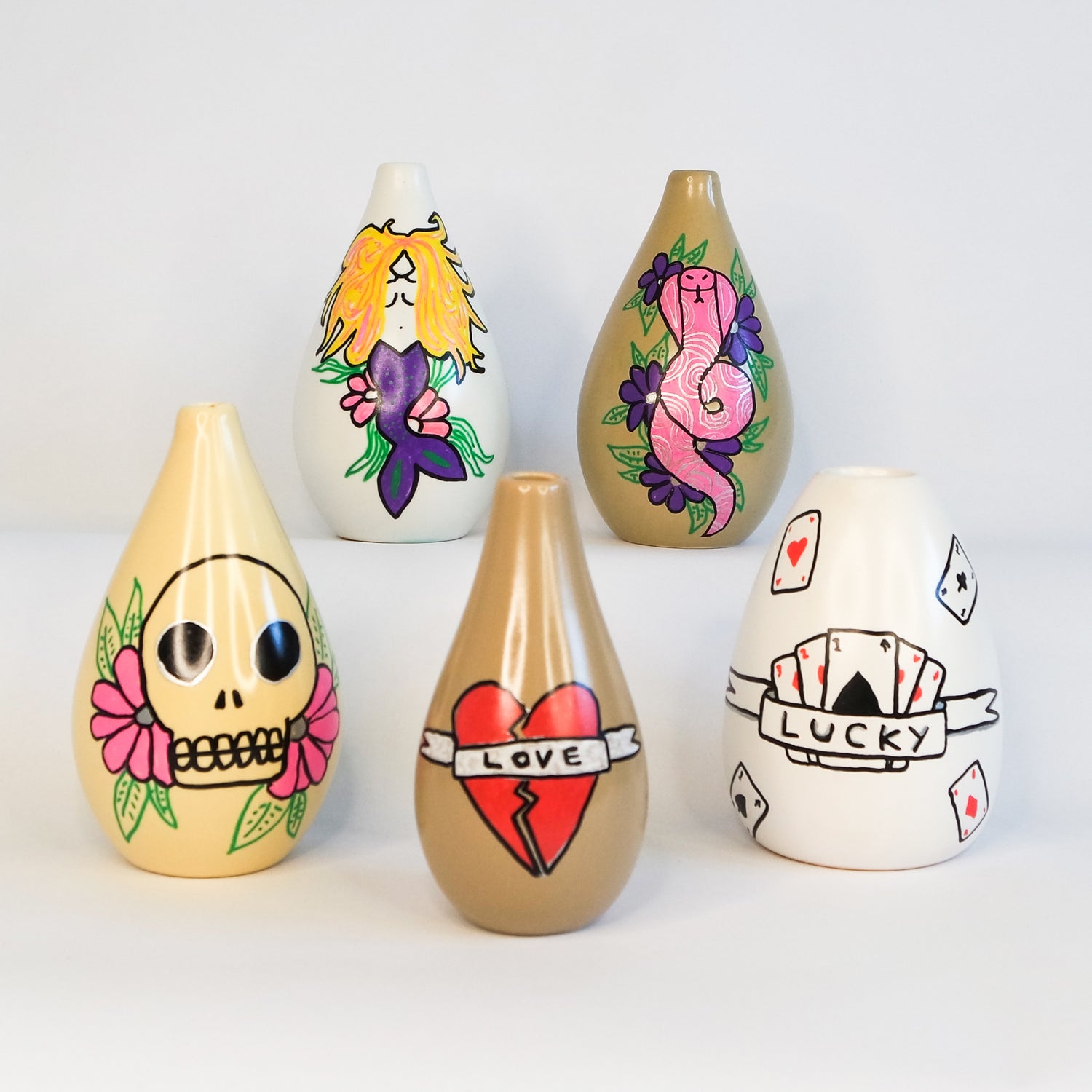 Bud vases with a range of tattoo style designs 